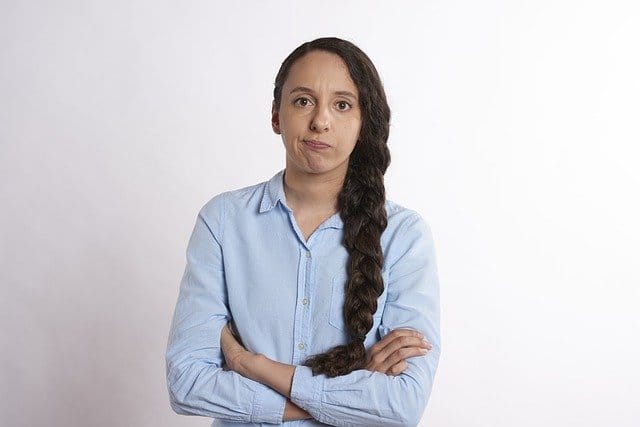 frustrated woman standing with her arms crossed