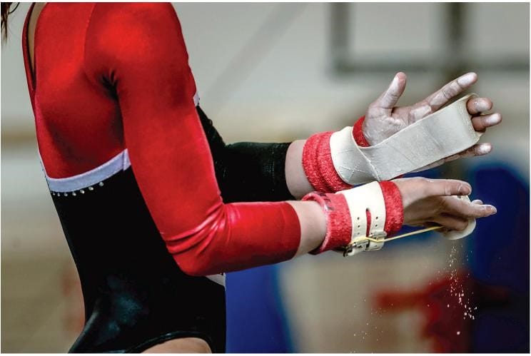 a collegiate gymnast warming up